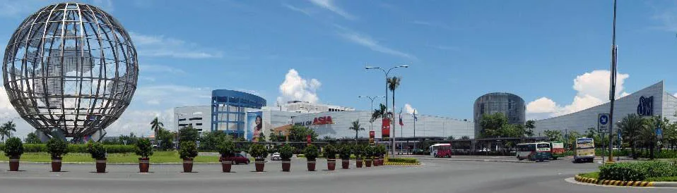 SM Mall of Asia's globe sculpture and main building under a daytime sky